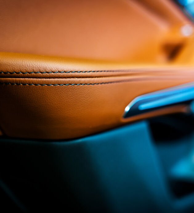 Brown leather seats in a car interior. Close-up of the seams